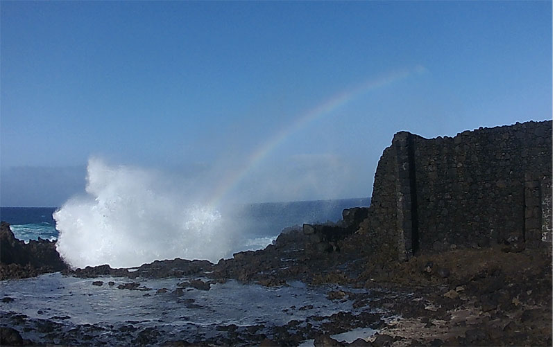 The old water pump for the salt works, Los Cancajos, Bre;a Baja, with a huge wave and a rainbow in the spray.
